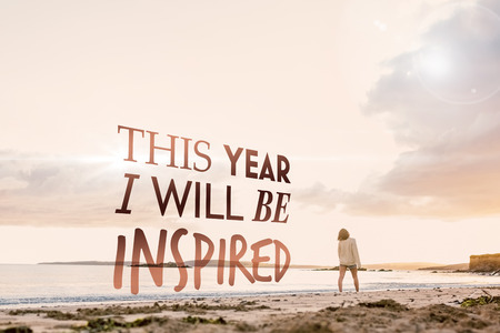 Woman in sweater walking on beach against i will be inspired