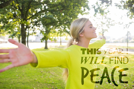 Fit smiling blonde enjoying the sun against this year i will find peaceの写真素材