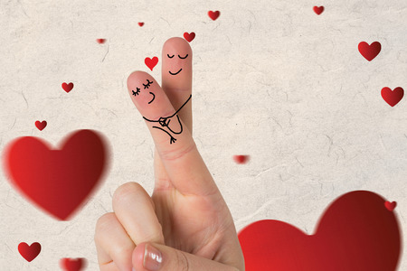 Fingers crossed like a couple against love heart patternの写真素材