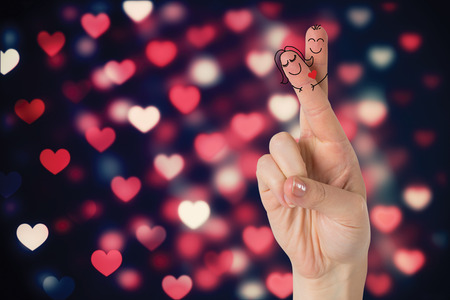 Fingers crossed like a couple against valentines heart patternの写真素材