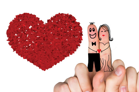 Fingers crossed like a couple against red love heartsの写真素材