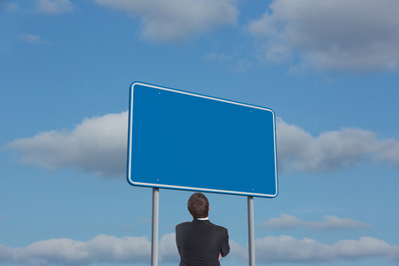 Thinking businessman against skyの写真素材