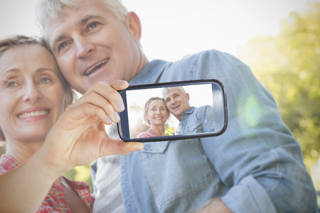 Composite of Couple taking selfie on smartphoneの写真素材