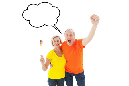 Happy german couple cheering at camera against speech bubbleの写真素材