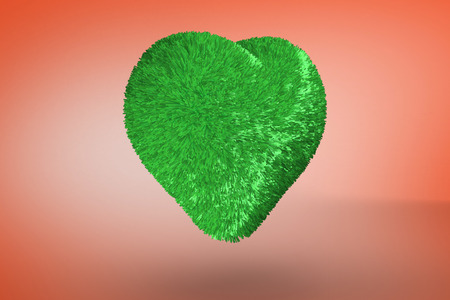 Green heart against orangeの写真素材