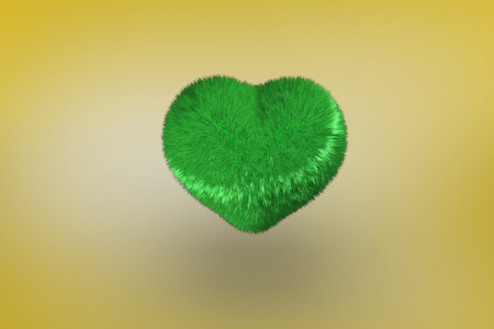 Green heart against yellow vignetteの写真素材