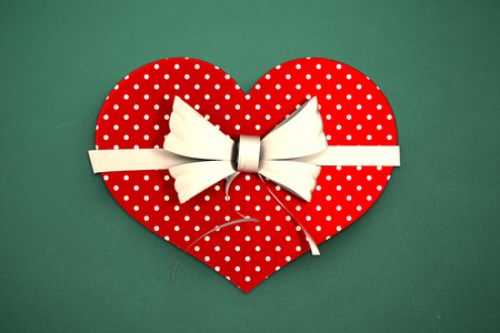 Heart shaped box of candy against greenの写真素材