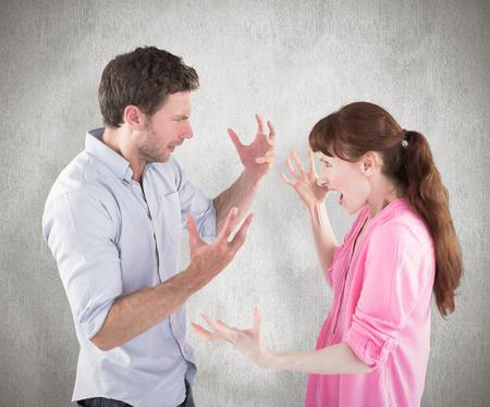 Couple arguing with each other against weathered surface