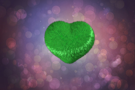 Green heart against purple abstract light spot designの写真素材