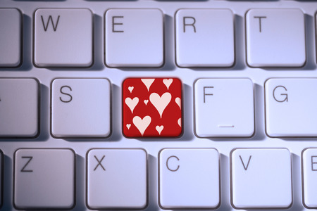 Valentines day pattern against red key on keyboardの写真素材