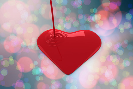 Liquid heart pouring against light glowing dots on blueの写真素材