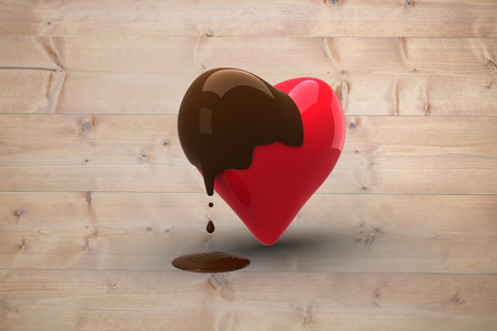 Heart dipped in chocolate against bleached wooden planks backgroundの写真素材