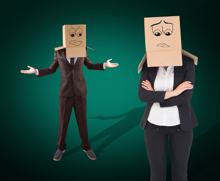 Businesswoman with box over head against green background with vignetteの写真素材