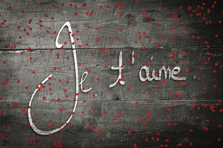 Red love hearts against overhead of wooden planksの写真素材