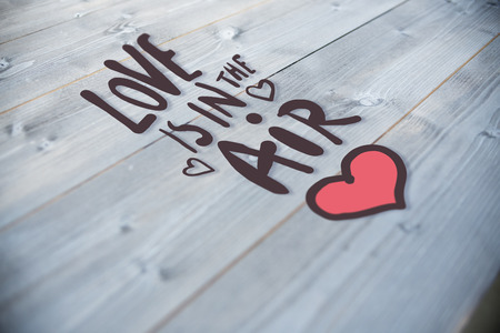 love is in the air against bleached wooden planks backgroundの写真素材