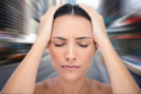Woman with headache against blurry new york street