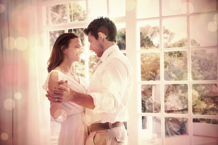 Side view of a loving young couple holding hands at homeの写真素材