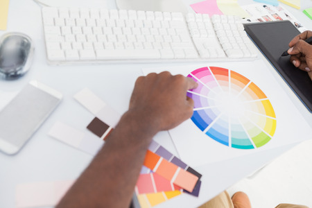 Designer using graphics tablet and colour wheel in the officeの写真素材