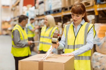 Warehouse workers preparing a shipment in a large warehouseの写真素材