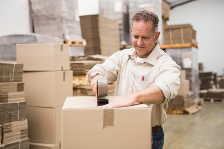 Warehouse worker preparing a shipment in a large warehouse