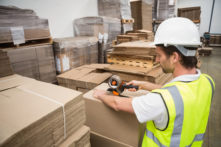 Warehouse worker preparing a shipment in a large warehouse