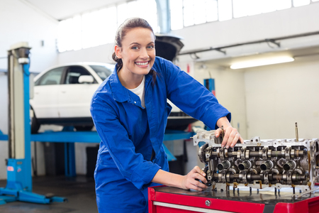 Mechanic working on an engine at the repair garageの写真素材
