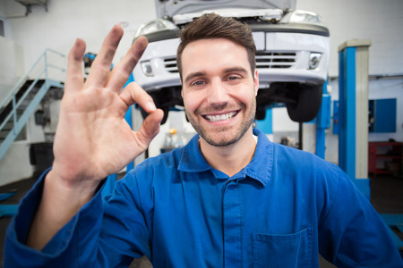 Mechanic smiling at the camera at the repair garageの写真素材