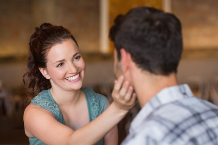 Young couple having coffee together at the cafeの写真素材