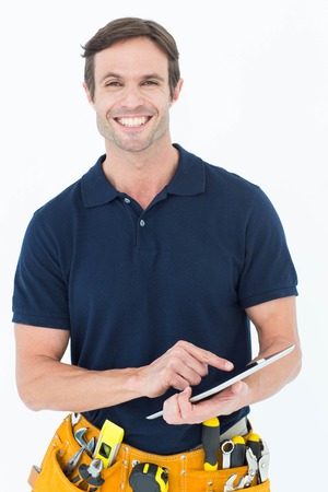 Portrait of happy handyman using digital table over white background