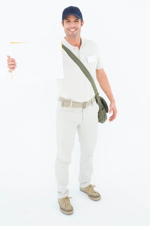 Portrait of happy courier man showing envelops on white background