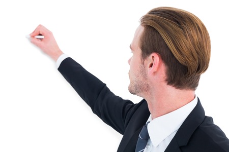 Well dressed businessman writing with chalk on white backgroundの写真素材