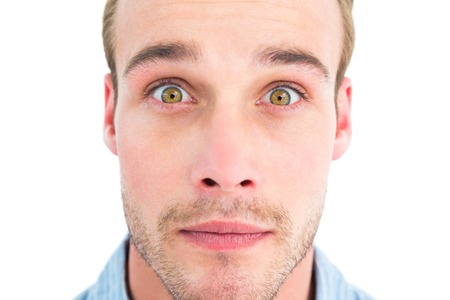 Surprised man in shirt looking at camera on white backgroundの写真素材