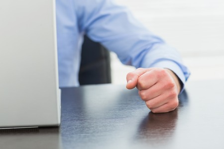 Angry businessman thump the table in his officeの写真素材