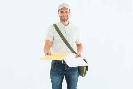 Portrait of happy courier man giving envelops on white backgroundの写真素材