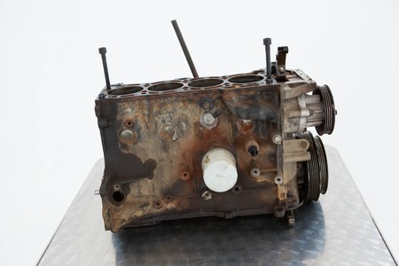 Close-up of old car engine on white backgroundの写真素材