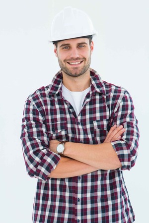 Portrait of handome male handyman standing arms crossed on white backgroundの写真素材