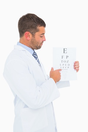 Doctor in lab coat showing eye test on white background