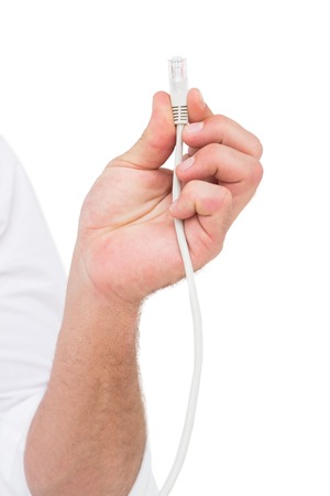 Businessman holding a cable on white background