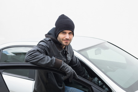 Car thief looking at camera in broad daylight