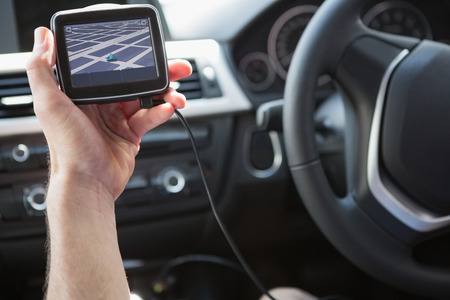 Man using satellite navigation system in his car