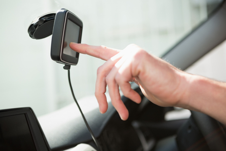 Man using satellite navigation system in his car