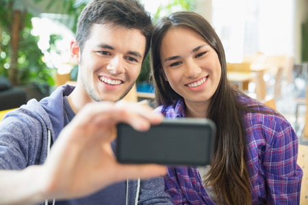 Young students taking a selfie at the universityの写真素材