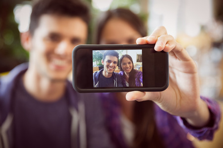 Young students taking a selfie at the universityの写真素材
