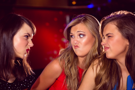 Pretty friends making funny faces at the nightclubの写真素材