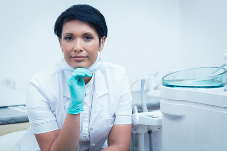 Portrait of confident female dentist with hand on chinの写真素材