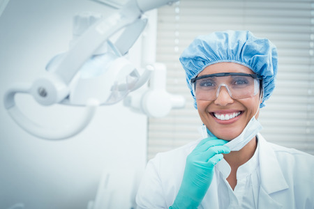 Portrait of female dentist wearing surgical cap and safety glassesの写真素材