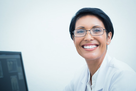 Close up portrait of smiling female dentistの写真素材