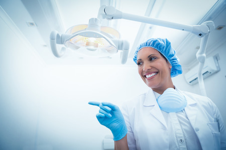 Low angle portrait of smiling female dentistの写真素材