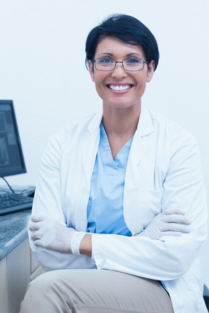 Portrait of smiling female dentist with arms crossedの写真素材