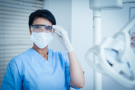 Portrait of female dentist wearing surgical mask and safety glassesの写真素材